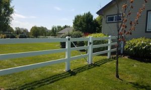 a white fence with gate on rural residential property