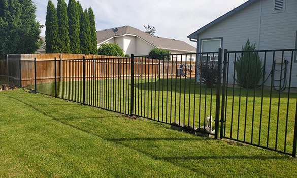 Minimalist ornamental aluminum fence installed on residential property